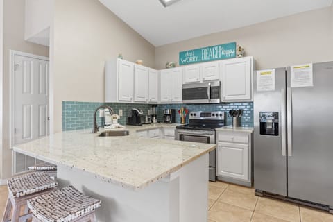 Updated kitchen with new quartz counters, tile backsplash and stainless appliances.