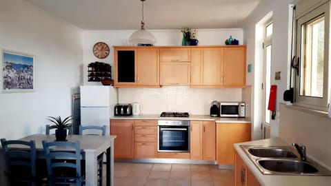 Kitchen and dining in the Apartment, door leading to outside courtyard.