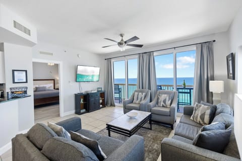 Relax in your spacious oceanfront living room where stunning sea views greet you through floor-to-ceiling windows and coastal breezes drift across comfortable seating.