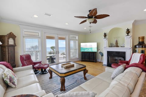 Relax in your spacious living room with ocean views and cozy fireplace for perfect evenings.