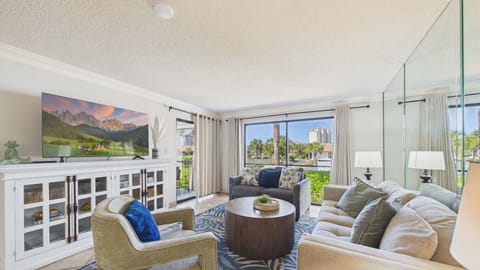 Open concept living area with stylish furnishings and queen sleeper sofa + balcony access (sleeps 2)
