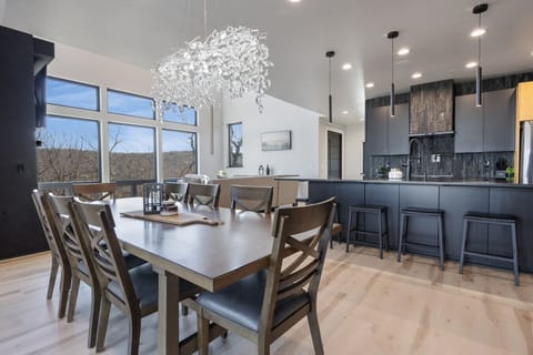 Fully stocked open concept kitchen with bar seating for 6 and dining table with seating for 8