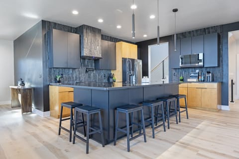 Fully stocked open concept kitchen with bar seating for 6 and dining table with seating for 8