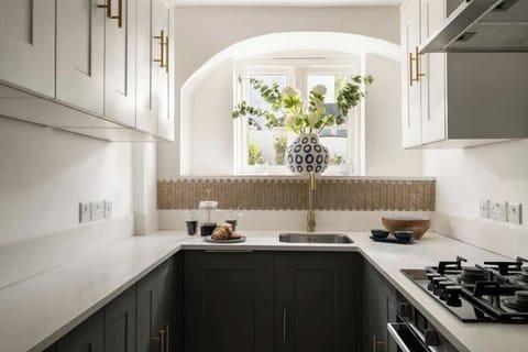 Morning light, fresh flowers, and a quiet cup of coffee - the kitchen’s a calm corner that sets the tone for the day ahead.