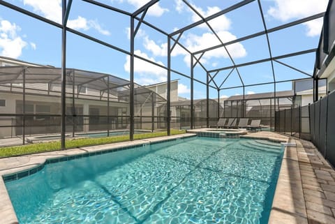 Enjoy a private screened pool area with lounge chairs for relaxing under the sun.