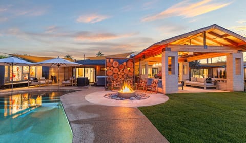 Private pool with covered patio and cozy fire pit, perfect for relaxing evenings and outdoor gatherings.