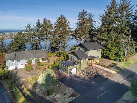 Waterfront property nestled among towering evergreens with stunning bay views and peaceful residential setting.