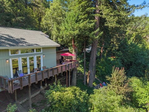 Riverfront vacation home with panoramic Russian River views, hot tub, seasonal kayaks, EV charger, dog-friendly amenities, and peaceful redwood surroundings near Guerneville.