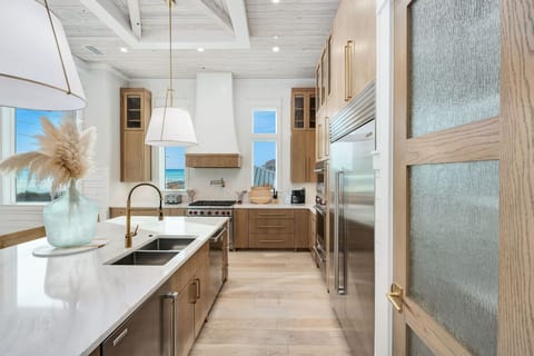 Your gourmet kitchen awaits with gleaming appliances, marble countertops, and ocean views inspiring every culinary adventure.