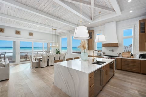 Cook with stunning gulf views through floor-to-ceiling windows in your dream beachfront kitchen.