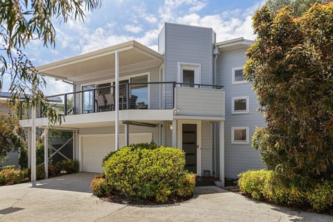 Front of the townhouse and the front entrance and double garage, with balcony looking towards the ocean.