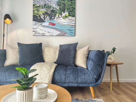 Comfortable lounge with cozy sofa and Queenstown artwork