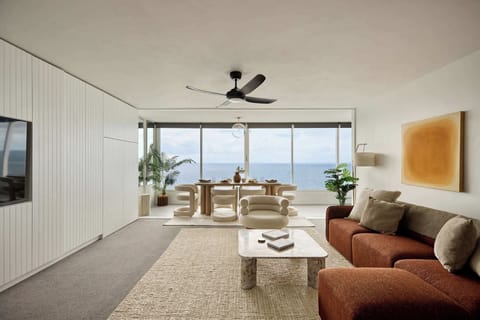 Experience effortless coastal living in this stylish open-plan retreat with stunning oceanfront views.