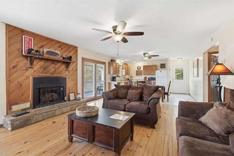 Cozy up by your warm fireplace in this inviting living space, where rustic wood meets comfortable seating for perfect relaxation.