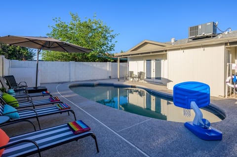 Poolside area with seating and games for a relaxing afternoon.