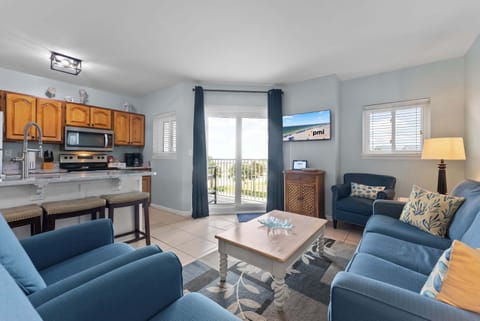 Bright living room with comfy seating and easy balcony access