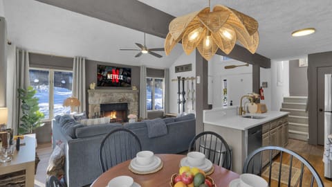 Enjoy the open layout with a stylish dining area and kitchen, complete with an island sink and counter—perfect for cooking and entertaining.