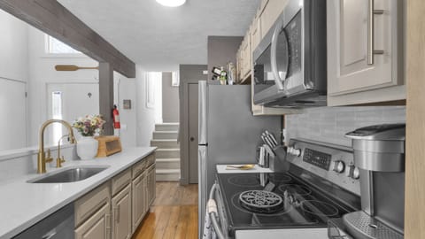 Fully equipped kitchen featuring a large fridge, oven stove, and microwave—everything you need to cook up your favorite meals during your stay.