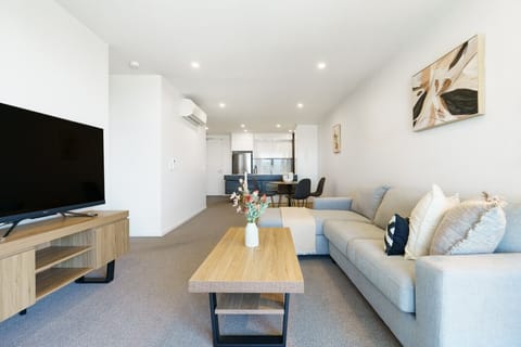 Stretch out on the comfy lounge and settle in for a movie night. This light-filled living space is designed for total relaxation.