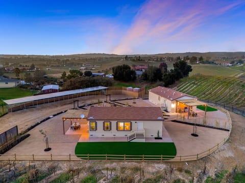 Sweeping vineyard views surround this private two-home Paso Robles retreat.