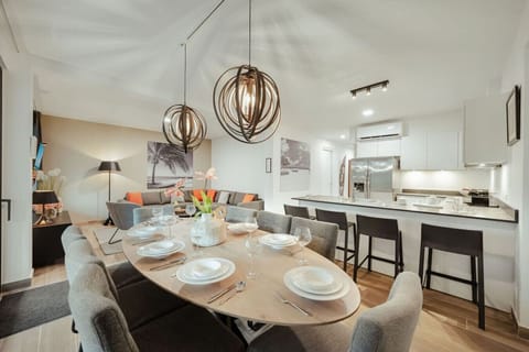 Bright, stylish open-plan retreat — dining, lounge & fully equipped kitchen ready for your stay.