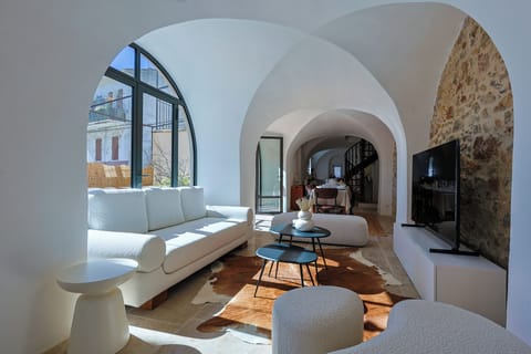 A spectacular vaulted living room where centuries-old stone meets serene modern design.