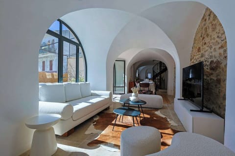 A spectacular vaulted living room where centuries-old stone meets serene modern design.