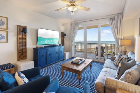 Relax in your coastal-themed living room with ocean views through floor-to-ceiling windows and step onto your private balcony.