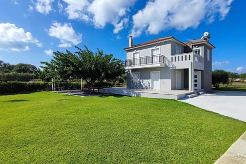 Property view with vast garden and outdoor furniture where you can relax and enjoy the view