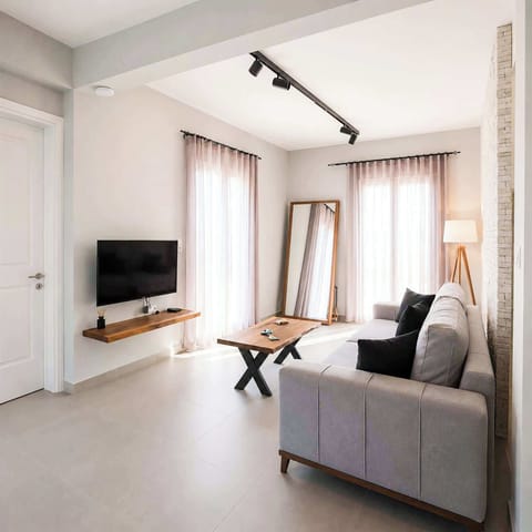 Contemporary open-plan lounge area with plenty of natural light and modern décor. Perfect for relaxing after visiting nearby beaches or exploring