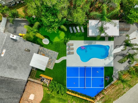 Bird's-eye view of your private backyard oasis - pool, pickleball court, putting green, fire pit and plenty of room to play