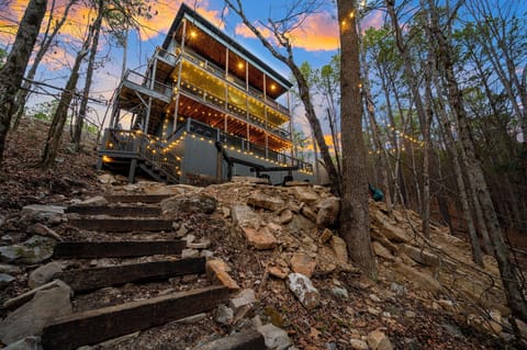 Three lit decks rising through the trees — The Delilah, Hochatown OK