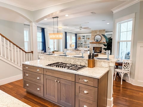 Seamless open layout—cook, connect, and unwind with the kitchen flowing right into the living room, and French doors leading  to the outdoors