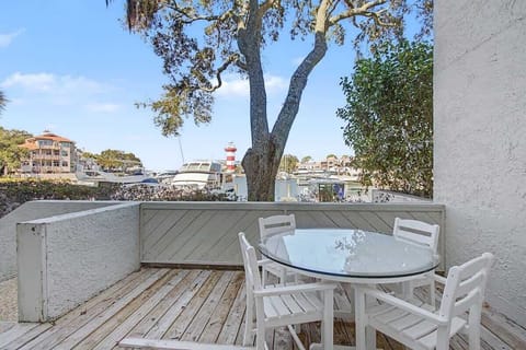 Enjoy morning coffee on your private deck overlooking the marina and famous lighthouse, with boats gently swaying and waterfront charm just steps away.