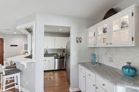 Your bright, coastal-inspired kitchen flows seamlessly to the dining area, perfect for preparing meals and gathering with loved ones.