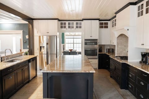 Your gourmet kitchen features granite countertops, stainless steel appliances, and a spacious island perfect for cooking memorable meals together.