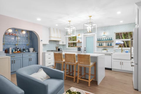 The heart of the home—this beautifully designed kitchen features a spacious island and breakfast bar, perfect for gathering and entertaining.