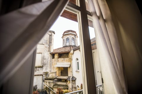 Deluxe Duplex, Balcony, Courtyard View | Living area | Flat-screen TV