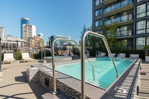 Rooftop outdoor pool with lounge seating and city views, offering a refreshing place to relax in the heart of Yaletown.
