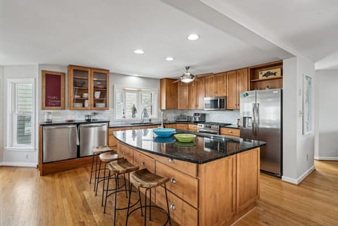 You'll love cooking in this spacious kitchen with granite countertops, stainless appliances, and breakfast bar seating.