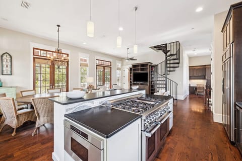 Your gourmet kitchen features a spacious island with professional-grade gas range, perfect for creating memorable meals together.