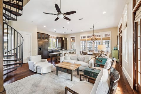 Relax in your spacious open-concept living space with soaring ceilings, elegant spiral staircase, and plush seating perfect for unwinding after exploring.