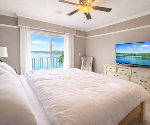 Wake up to stunning lakefront views in this bright and spacious master suite featuring a plush king bed, private balcony access, and modern comforts
