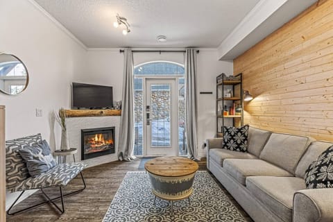 Comfy living room equipped with a fireplace, TV and a queen-sized sofa bed for larger groups.