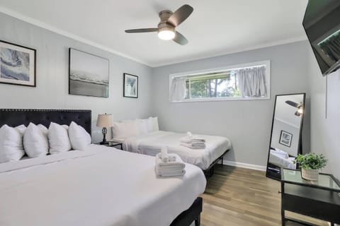 Spacious bedroom with two queen beds and soft linens for a great night’s sleep.