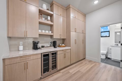 A large well appointed chef's kitchen with massive island, additional seating, butlers pantry, and high end appliances