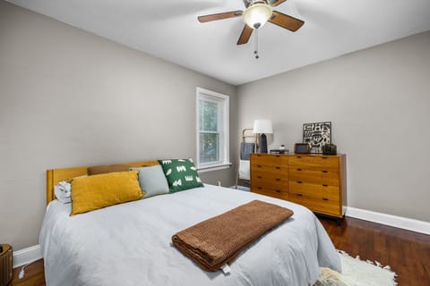 Cozy bedroom featuring hardwood floors and natural light