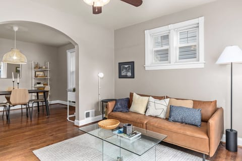Bright living room with warm hardwood floors and an open flow into the dining area