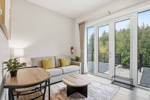 Living area and dining area with large windows and entrance. 