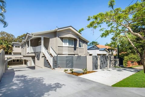 A secure low-rise townhouse exterior with direct driveway access.